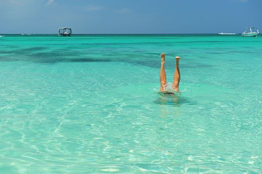 feet staying in a caribbean blue water