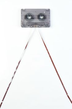 Audio casette with tape on a white background