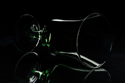 silhouette of glass laying on a black background