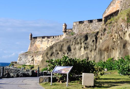 People walk next to castle in Puerto Rico