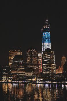Manhattan scyscraper reflect  lights in water at night