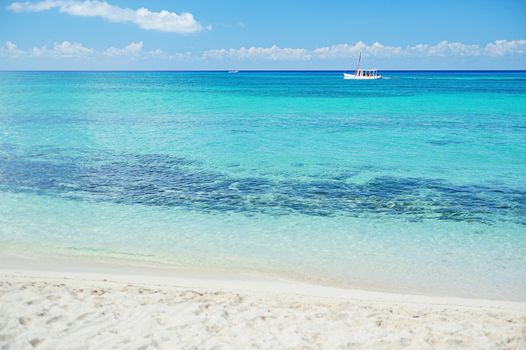 view of boat moving in crystal water from beach