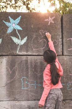 Young girl with brown hair is playing outside.