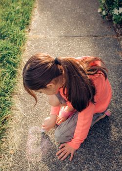 Young girl with brown hair is playing outside.