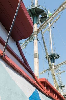 The masts of a sailboat with furled sails.