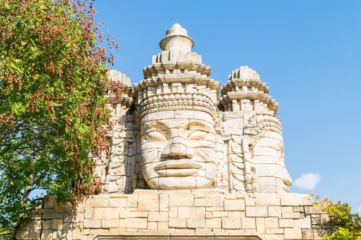 Stone faces of a temple in the forest.