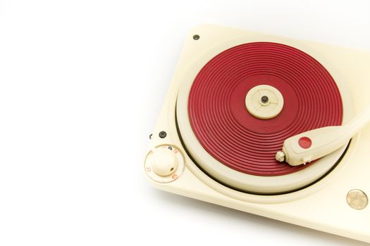 Vintage red record player on white background with copy space on the left.