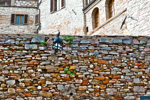 Old Wall on the Background of the Buildings in the Italian Medieval City