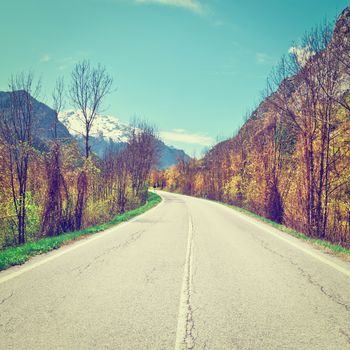 Asphalt Road in Piedmont on the Background of Snow-capped Alps, Instagram Effect