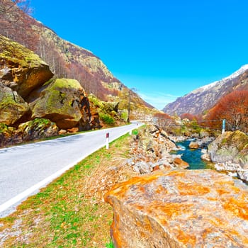 Asphalt Road along  Mountain Stream in the Italian Alps, Piedmont