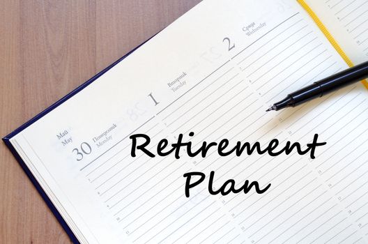 Retirement plan text concept write on notebook with pen
