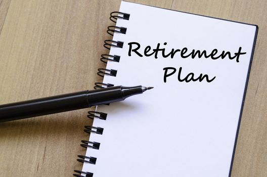 Retirement plan text concept write on notebook with pen