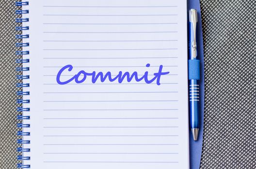 Commit text concept write on notebook with pen