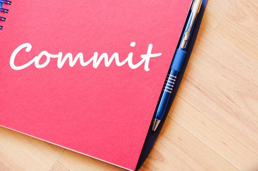 Commit text concept write on notebook with pen