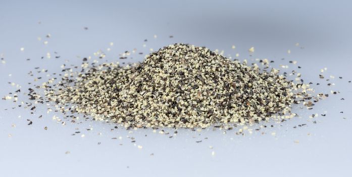 Black Pepper Grains in a pile close up.