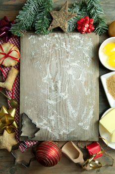 Christmas baking ingredients around a chopping board with background space