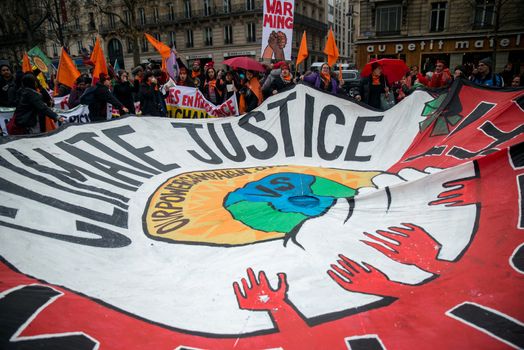 FRANCE, Paris : A giant sign reading Climate justice is seen among thousands demanding climate justice and environment protection in Paris on December 12, 2015. A climate march was organized by several NGOs as COP21 negotiations come to an end. 