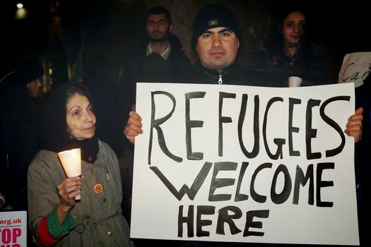 ENGLAND, London: People in support of the refugees gathered in London on December 12, 2015 to hold a Christmas vigil outside Downing Street.The demonstrators held candles and signs calling for refugees to be welcomed.