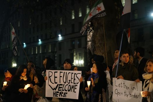 ENGLAND, London: People in support of the refugees gathered in London on December 12, 2015 to hold a Christmas vigil outside Downing Street.The demonstrators held candles and signs calling for refugees to be welcomed.