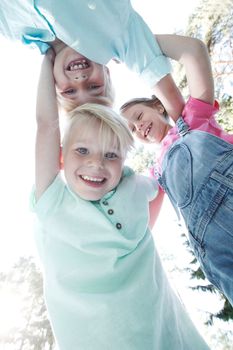 Group of smiling children looking down into camera