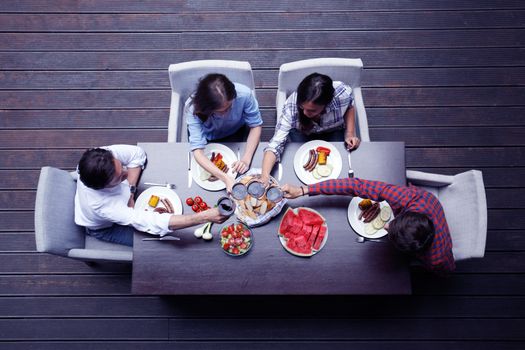 Four friends having dinner, top view