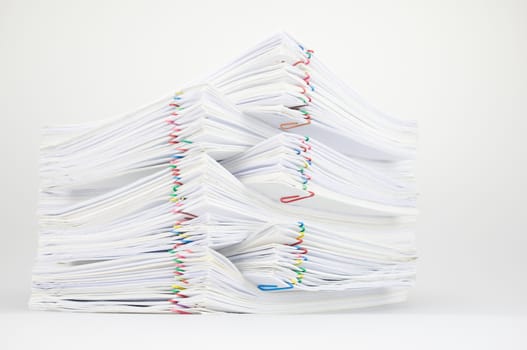 Pile of document with colorful paper clip place on white table.