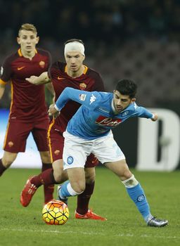 ITALY, Naples: Elseid Hysaj (right) of SSC Napoli fights for the ball with Edin Dzeko (left) of AS Roma during a Serie A match at Stadio San Paolo in Naples, Italy on December 13, 2015. 