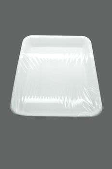 Wrapped white styrofoam food tray