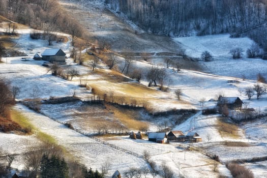 Frozen sunny day of a winter, on wild transylvania hills. Holbav. Romania. Low key, dark background, spot lighting, and rich Old Masters