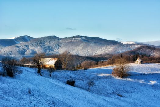 Frozen sunny day of a winter, on wild transylvania hills. Holbav. Romania. Low key, dark background, spot lighting, and rich Old Masters