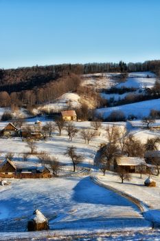 Frozen sunny day of a winter, on wild transylvania hills. Holbav. Romania. Low key, dark background, spot lighting, and rich Old Masters