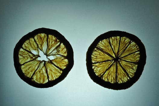 2 pieces of dried slice orange in sillhouette on the lighting table