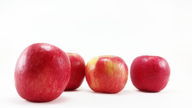 4 fresh red apples in  white background with selective focus