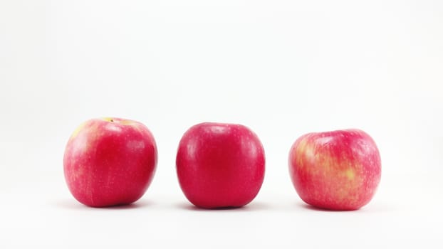 3 red apples in the row in white background