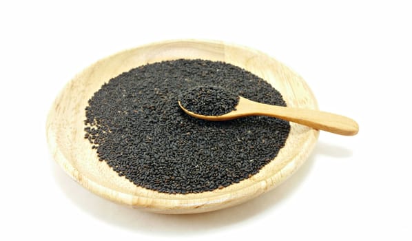 a spoon full hoary basil seed on hoary basil seed wooden plate