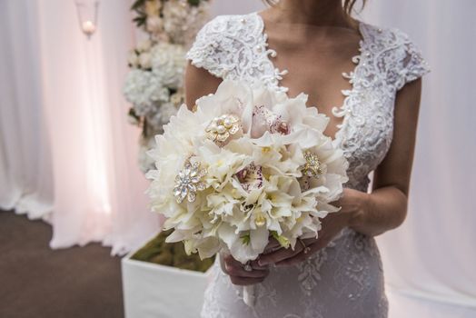 Image closeup of bride holding a beautiful bouquet