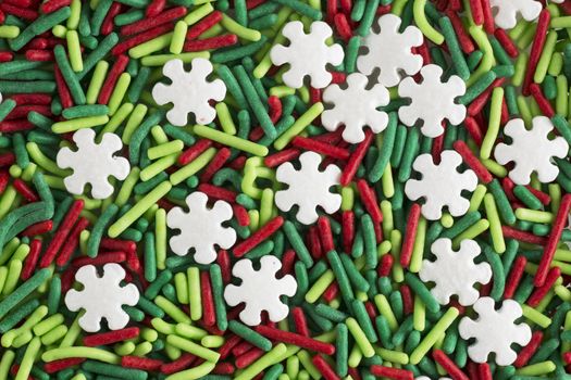 Green and red candy sprinkle decorations, with white snowflake shaped sprinkles