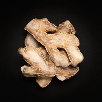 Top view of a Dried Ginger root or Sonth (Zingiber officinale) isolated on dark background.