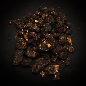 Top view of Organic Indian bdellium or Guggul resin (Commiphora wightii) isolated on dark background.