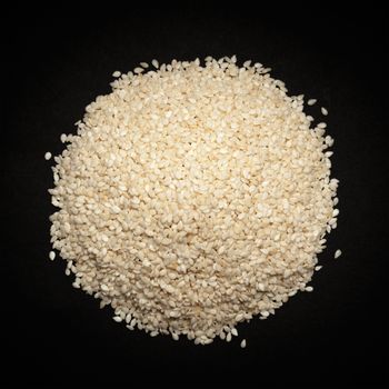 Top view of Organic Sesame white (Sesamum indicum) isolated on dark background.