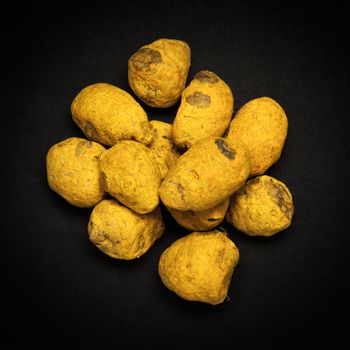 Top view of Organic Round Turmeric or Haldi (Curcuma longa) isolated on dark background.