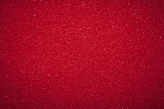 Background texture of solid red color made of soil.
