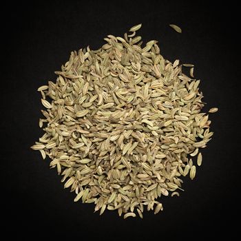 Top view of Organic Fennel seed (Foeniculum Vulgare) isolated on dark background.