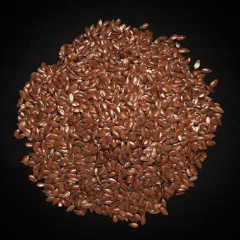 Top view of Organic Linseed or Flaxseed (Linum usitatissimum) isolated on dark background.