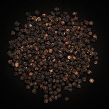 Top view of Organic Black pepper (Piper nigrum) isolated on dark background.