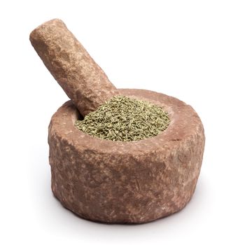 Organic Aniseed (Pimpinella anisum) in mortar with pestle, isolated on white background.