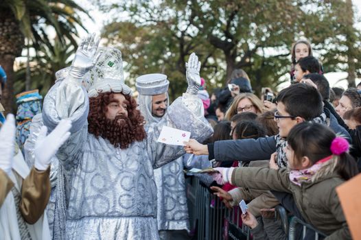 SPAIN, Barcelona: One of the revelers dressed as the Three Wise Men  Caspar, Balthazar and Melchior  is cheered by children in Barcelona for the annual Three Kings Day parade on vigil of Epiphany day, on January 5, 2016. The annual procession, attended by thousands, celebrates the historic arrival of the Three Wise Men to Bethlehem, and marks the end of the Christian holiday season.