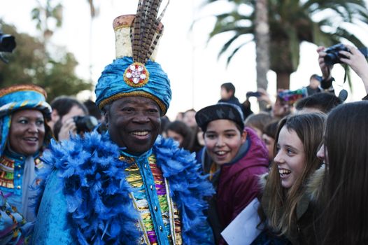 SPAIN, Barcelona: One of the revelers dressed as the Three Wise Men  Caspar, Balthazar and Melchior  is cheered by children in Barcelona for the annual Three Kings Day parade on vigil of Epiphany day, on January 5, 2016. The annual procession, attended by thousands, celebrates the historic arrival of the Three Wise Men to Bethlehem, and marks the end of the Christian holiday season.