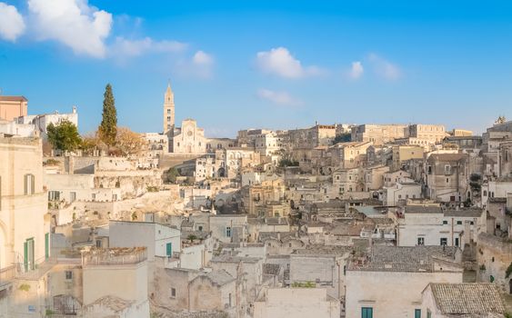 panoramic view of typical stones (Sassi di Matera) and church of Matera UNESCO European Capital of Culture 2019 under blue sky. Basilicata, Italy