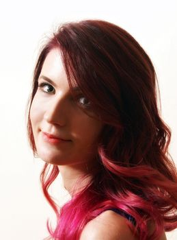 A young adult woman showcases her new modern ombre hairstyle done professionally at the salon.